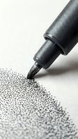 Black marker pen with fine tip creating dotted line pattern on white paper, suitable for art, design, and creative projects.