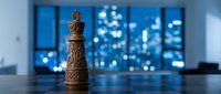 Wooden chess queen piece standing on reflective surface with blurred city lights and skyscraper windows in background, symbolizing strategy, leadership, and business success.