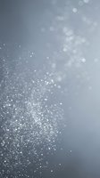 Abstract silver gray background with sparkling glitter particles and soft bokeh lights creating elegant festive atmosphere for luxury design projects.