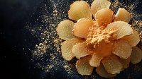 Orange flower-shaped dessert with powdered sugar dust scattered on dark background, creating elegant culinary presentation for restaurant menu or food photography.