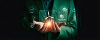 Businessman in green suit holding glowing wind turbine with renewable energy icons floating above hands representing sustainable power solutions.