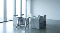 Modern glass conference table with gray chairs in bright office meeting room with large windows and natural light for business presentations.