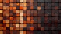 Geometric pattern of wooden blocks in varying shades of brown, orange, and black creating modern mosaic wall texture. Natural wood grain adds organic detail.