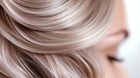 Close up view of platinum blonde hair with soft waves and natural highlights showing smooth texture and professional salon styling for beauty and haircare advertising.