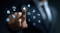 Business professional touching glowing digital icons displaying legal, financial and technology symbols on dark background, representing digital transformation.