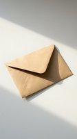 Kraft paper envelope on white surface with natural shadow lighting for correspondence and mailing needs.