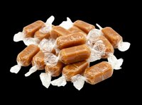Wrapped caramel candies pile isolated on transparent background, ready for sticker, clipart, print on demand, sublimation, and t-shirt design use.