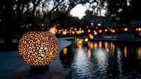 Glowing ornate lantern hanging over tranquil water at dusk, with soft bokeh lights reflecting across rippling surface creating romantic evening ambiance.
