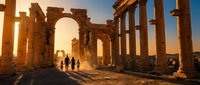 Ancient Roman ruins with stone columns and arches at golden hour sunset, tourists exploring archaeological site with dramatic lighting and historical architecture.