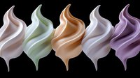 Smooth swirling cream shapes in pastel colors of pink, mint, caramel, white and purple arranged in row on black background, isolated cosmetic texture.