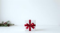 White gift box with red ribbon bow and evergreen branch with berries on white surface, suitable for holiday marketing, seasonal promotions, and festive greeting card designs.
