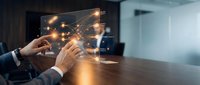 Business professional using futuristic holographic interface technology with glowing network connections on modern office desk for digital transformation.