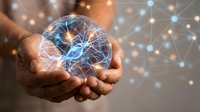 Hands holding glowing digital brain with neural network connections, representing artificial intelligence, machine learning, and innovative technology solutions for business.