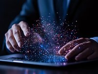 Male hands typing on laptop keyboard with magical glowing particles emerging, creating ethereal pink and blue light effect against dark background. Digital transformation concept.