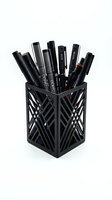 Black marker pens and fine-tip art supplies organized in geometric patterned holder on white background, isolated for design and product mockup use.