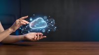 Hands presenting holographic cloud computing network with digital icons floating above smartphone on wooden desk for technology presentations.