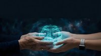 Hands exchanging glowing digital cube representing technology transfer, innovation collaboration, and data sharing between generations in modern business environment.
