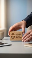 Businessman hands protecting wooden block with customer service excellence text and handshake icon on office desk for quality assurance concept.