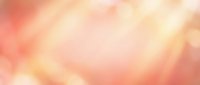Soft peachy and golden bokeh background with warm blurred lights, suitable for overlays, presentations, and design projects.