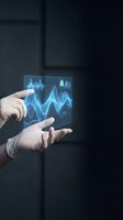 Businessman hands displaying holographic data analytics charts and graphs with glowing blue waveforms for financial technology presentations.