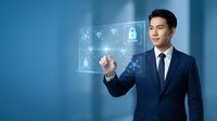 Professional Asian businessman in navy suit touching digital security interface with cybersecurity icons in modern blue office environment for technology presentations.