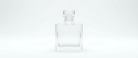 Empty clear glass perfume bottle with square design and crystal stopper on white background isolated for product photography and cosmetic branding.