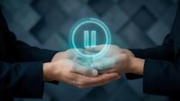 Businessman hands holding glowing pause button icon with digital interface elements for business control and workflow management applications.