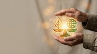 Hand holding glowing leaf and plant icons on balance scale, symbolizing environmental sustainability, eco-friendly business practices, and green energy solutions for corporate responsibility.