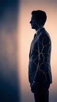 Male professional, South Asian ethnicity, wearing business attire with glowing neural network pathways overlaid on torso, silhouetted against warm gradient background. Represents artificial intelligence, digital transformation, and innovation in business.