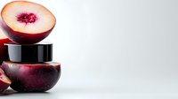 Fresh cut ripe nectarine half balanced on black cosmetic jar showing natural fruit extract ingredient for skincare and beauty products on light background.