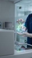 Scientist in laboratory holding glowing DNA helix hologram between hands showcasing genetic research and biotechnology innovation in modern medical facility.