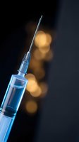 Medical syringe with needle against dark background with warm bokeh lights for healthcare and vaccination concepts.