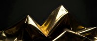Shiny gold metallic peaks and valleys creating an abstract geometric landscape with dramatic lighting against dark background.