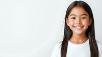 Young Asian girl with long dark hair wearing white t-shirt smiling brightly against light background, showing genuine happiness and positive emotions.