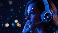 Young woman wearing blue gaming headset with microphone in neon lighting against starry night sky background for esports and streaming content.
