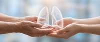 Hands holding glowing lungs symbol representing respiratory health care, medical protection and breathing wellness concept for healthcare design.