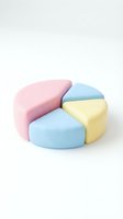 Colorful makeup sponges arranged in circular pattern on white background for beauty and cosmetics applications.