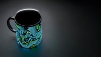 Black coffee mug with glowing blue circuit board pattern on dark surface. Technology themed drinkware for tech enthusiasts and digital professionals.