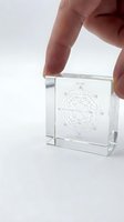 Hand holding transparent crystal cube with organizational network diagram showing business hierarchy and department connections on white background.