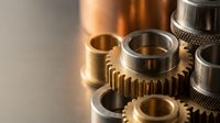 Precision metal gears and mechanical components showcasing industrial engineering craftsmanship with golden lighting for manufacturing concepts.