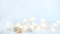 Wedding rings and decorative elements with warm bokeh lights creating romantic atmosphere for bridal ceremonies and celebrations.