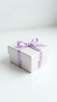 White gift box with purple ribbon bow on clean background for special occasions and celebrations.