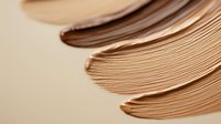 Stack of brown kraft paper sheets with curved edges creating organic flowing lines and natural texture for packaging and craft projects.