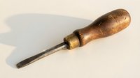 Vintage wooden handle chisel tool for woodworking crafts and carpentry projects isolated on white background ready for design use.