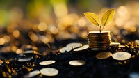 Small green plant growing from stack of coins on soil with scattered money, golden bokeh background illuminated by sunlight. Financial growth concept.