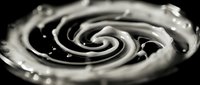 Monochrome spiral swirl with water droplets and dynamic motion against dark background, suitable for abstract backgrounds, creative design projects, and modern artistic compositions.