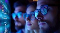 Young professionals wearing glasses analyzing data on computer screens in modern office environment with blue digital lighting and code reflections.