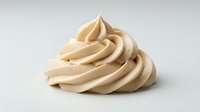 Swirled vanilla or caramel frosting piped in soft peaks, isolated on white background, ready for bakery, dessert, and confectionery design projects.