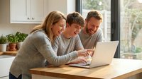 Happy family with teenage son using laptop computer together in modern kitchen for online learning and bonding time at home.
