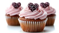 Chocolate cupcakes topped with pink buttercream frosting and dark chocolate heart decorations on white background, selective focus on center treat for Valentine's Day celebration.